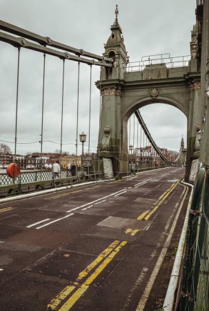 Photo for London, UK - Dec 25, 2023 - Hammersmith Bridge over the River Thames. One of the world's oldest suspension bridges and a major river crossing and primary route in west london, Space for text, Selective focus. - Royalty Free Image