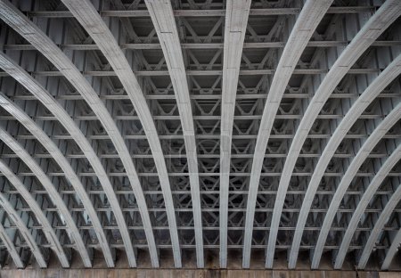 Framework metal arches girder construction Underneath of Blackfriars Bridge. View of Structure and beams under the Curved steel Bridge, Riveted steel beams supporting bridge span, Copy space, Selective focus.