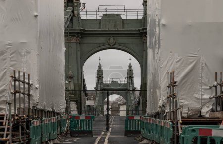 Photo for London, UK - Dec 25, 2023 - Hammersmith Bridge closed for while undergoing a complete refurbishment and repairing. One of the world's oldest suspension bridges and a major river crossing and primary route in west london, The approach to a heavily clo - Royalty Free Image