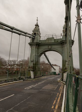 London, UK - Dec 25, 2023 - Hammersmith Bridge over the River Thames. One of the world's oldest suspension bridges and a major river crossing and primary route in west london, Space for text, Selective focus.