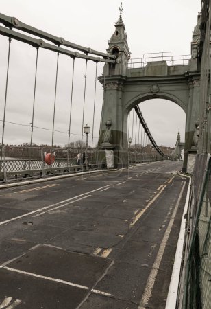 Photo for London, UK - Dec 25, 2023 - Hammersmith Bridge over the River Thames. One of the world's oldest suspension bridges and a major river crossing and primary route in west london, Space for text, Selective focus. - Royalty Free Image
