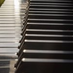 Piano keys side view with shallow depth of field. Classic grand piano keyboard background, Space for text, Selective focus.