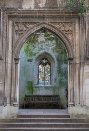 Photo for London, UK - Feb 27, 2024 - Stone staircase leads to The stone arched entrance inside of St Dunstan in the East Church Garden with Stone window frame and Wooden benches. The historic church was bombed and destroyed in the Second World War and is now - Royalty Free Image