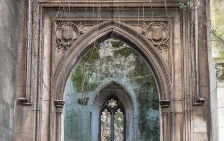 Photo for London, UK - Feb 27, 2024 - Perspective view of The stone arched entrance and Stone window frame inside of St Dunstan in the East Church Garden. The historic church was bombed and destroyed in the Second World War and is now a park, London city hidde - Royalty Free Image
