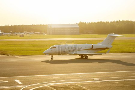 Photo for A small luxury private business jet on the airport runway strip - Royalty Free Image