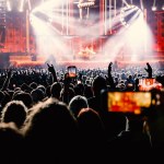 People with mobile phones record a music concert