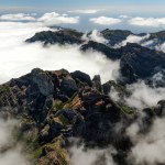 Drone view of Madeira Mountains Pico do Arieiro, Portugal. Rocky peaks over the clouds