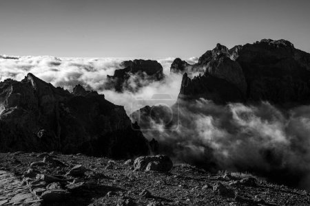 Photo for Mountain peaks among the clouds. Black and white - Royalty Free Image
