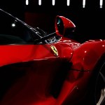 Maranello, Italy - April 01, 2023: Side view of a red Ferrari sports car with a streamlined body and mirror