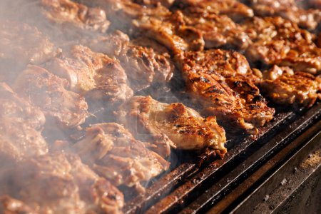 Photo for Pork steaks cooking in open flame on barbecue grill - Royalty Free Image