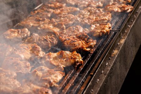 Photo for Chicken meat steaks are fried on fire, bbq grill service - Royalty Free Image
