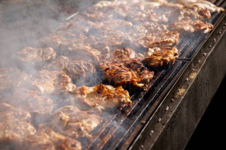 Photo for Pieces of juicy meat are fried on fire - Royalty Free Image