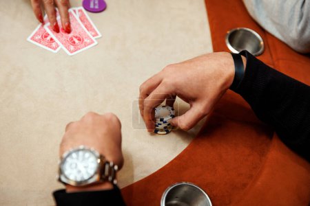 Player with chips at a table in a casino