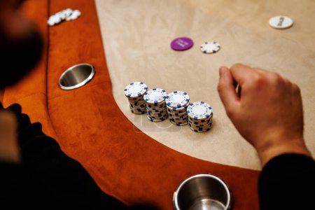 The player hand is hovering over a stack of chips, ready to make the next big move
