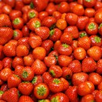 A bountiful collection of ripe, glossy strawberries. Strawberry background