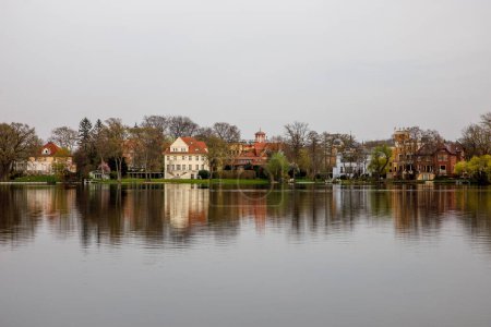 Calm view of lake water and shore with houses in Potsdam, Germany