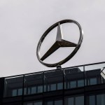 Berlin, Germany - April 1 , 2024: Rotating Mercedes logo on the roof of an office building