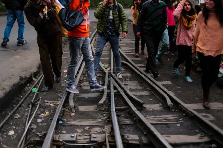 Photo for Kolkata, India. June 13, 2019 : People crossing the railway track and not using footover bridge. Many people loose their life in this illegal and risky activity. - Royalty Free Image