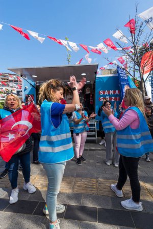 Photo for Istanbul, Turkey - May 13 2023: Supporters of Kemal Kilicdaroglu dancing while holding the Turkish flags in front of Republican Peoples Party kiosk in Uskudar neighbourhood during 2023 elections - Royalty Free Image