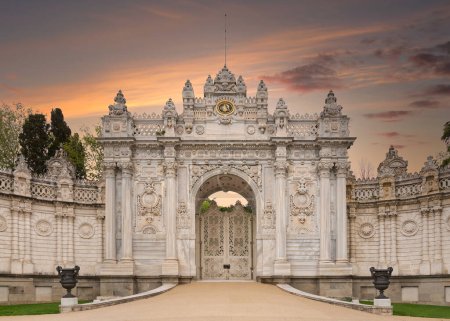 Photo for Sunset shot of closed gate leading to former Ottoman Dolmabahce Palace, or Dolmabahce Sarayi, suited in Ciragan Street, Besiktas district, Istanbul, Turkey. View from the internal court - Royalty Free Image