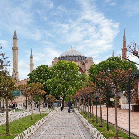 Photo for Istanbul, Turkey - May 11, 2023: Group of people walking down a sidewalk in front of the Hagia Sophia, a UNESCO World Heritage Site. The Hagia Sophia is a former church, museum, and now mosque - Royalty Free Image