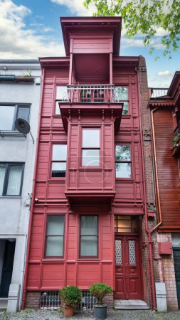 Red residential building at an alley suited in Kuzguncuk neighborhood, Uskudar district, Istanbul, Turkey
