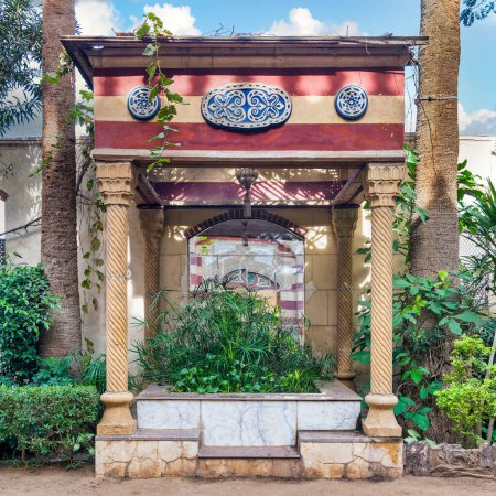 Charming stone gazebo with carved columns nestled amidst lush greenery in a serene urban garden