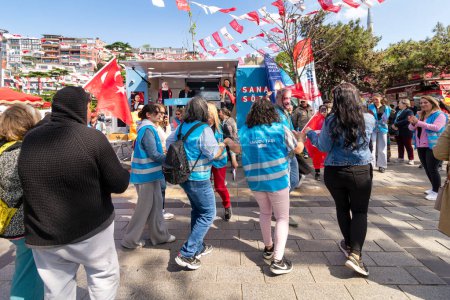 Photo for Istanbul, Turkey - May 13 2023: Supporters of Kemal Kilicdaroglu dancing while holding the Turkish flags in front of Republican Peoples Party kiosk in Uskudar neighbourhood during 2023 elections - Royalty Free Image