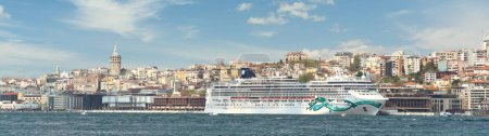 Norwegian Jade, Huge cruise ship docked at Galataport terminal along the Bosphorus, in Karakoy neighbourhood, Istanbul, Turkey, with Galata Tower in the far end