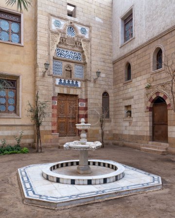 A tranquil courtyard with marble fountain at Prince Naguib Palace showcasing Mamluk architecture in Cairo, Egypt