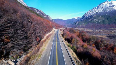 Photo for Patagonia road at Ushuaia Argentina province of Tierra del Fuego. Stunning road between nevada mountains and colorful forest trees. Ushuaia Argentina. Patagonia Argentina at Ushuaia Argentina. - Royalty Free Image
