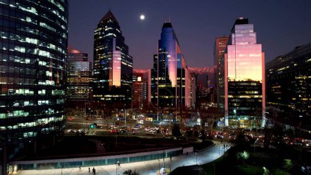 Photo for Sunset at Santiago Chile. Cityscape of sunset sky at city Santiago Chile. Scenic landscape of colorful reflection of sky in towers offices buildings and skyscrapers. Urban life scenery. - Royalty Free Image