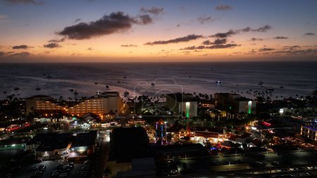 Photo for Caribbean Sunset At Oranjestad In Caribbean Netherlands Aruba. Cityscape Skyline. Sunset Downtown. Oranjestad At Caribbean Netherlands Aruba. Luxury Hotel Landmark. Bright Buildings. - Royalty Free Image