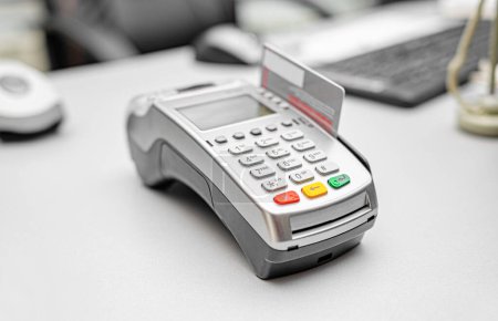 Photo for Bank payment terminal on the office desk. - Royalty Free Image