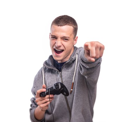 Photo for Positive young guy with a gamepad in his hands against a white background close-up. - Royalty Free Image