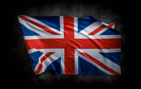 Téléchargez les photos : UK flag on a dark background. Great Britain flag on the background of a dark canvas for a patriotic concept and national celebrations. - en image libre de droit