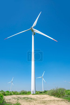 Photo for Wind farm outside the city against the blue sky. - Royalty Free Image