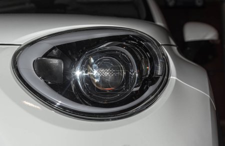 Photo for Round headlight of a white new car from close - Royalty Free Image