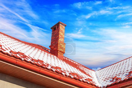 Photo for Snow on the roof at winter on the background of blue sky. - Royalty Free Image