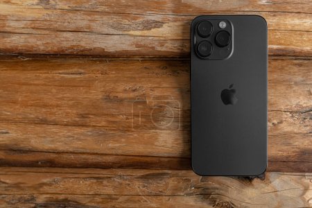 Photo for Uzhgorod, Ukraine - May 05, 2023: New Apple iPhone 14 Pro Max Space Black on a wooden background. - Royalty Free Image