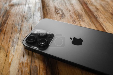 Photo for Uzhgorod, Ukraine - May 05, 2023: New Apple iPhone 14 Pro Max Space Black on a wooden background. - Royalty Free Image