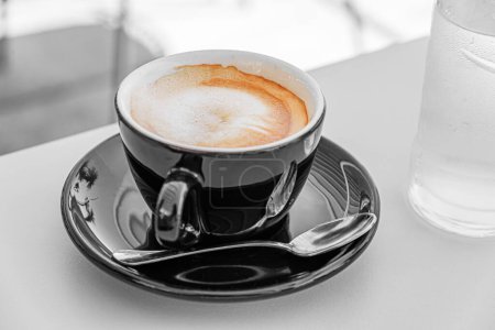 Photo for Cup of aromatic black coffee on a wooden table. - Royalty Free Image