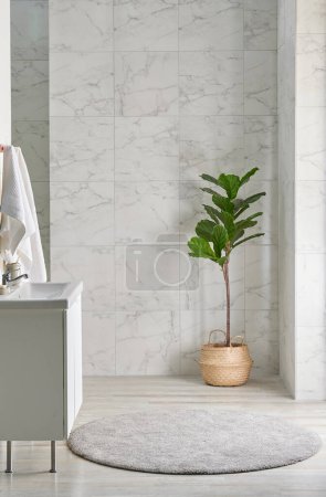 Foto de Estilo interior del cuarto de baño con espejo del gabinete y fondo de cerámica blanca, material de limpieza, toalla, jarrón de mimbre de la planta, decoración interior. - Imagen libre de derechos