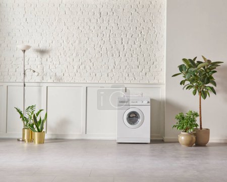 Photo for Washing machine in the bathroom, white brick wall background, vase of plant, cabinet and marble floor, folding screen. - Royalty Free Image