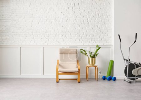 Photo for Rocker chair in the white room, brick and classic wall background, Sport, chamber, green plant leaf close up blur, working table. - Royalty Free Image