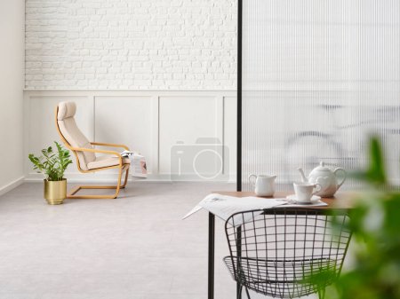 Photo for Rocker chair in the white room, brick and classic wall background, chamber, green plant leaf close up blur, working table. - Royalty Free Image