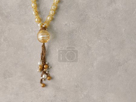 Photo for Yellow rosary.Product still life concept. Modern and decorative textured background. - Royalty Free Image