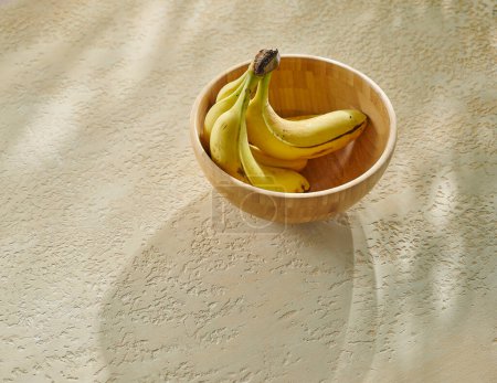 Photo for Delicious bananas on the decorative concrete background. - Royalty Free Image