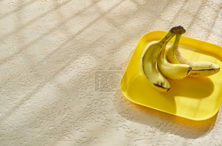 Photo for Delicious bananas on the decorative concrete background. - Royalty Free Image