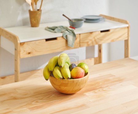 Photo for Close up fruit basket on the wooden table, kitchen background, banana, apple and pear. - Royalty Free Image